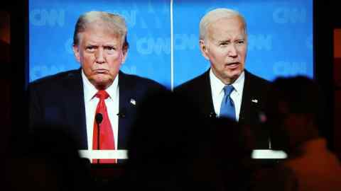 A TV screen shows Joe Biden, right, and Donald Trump during their first debate of 2024 on CNN