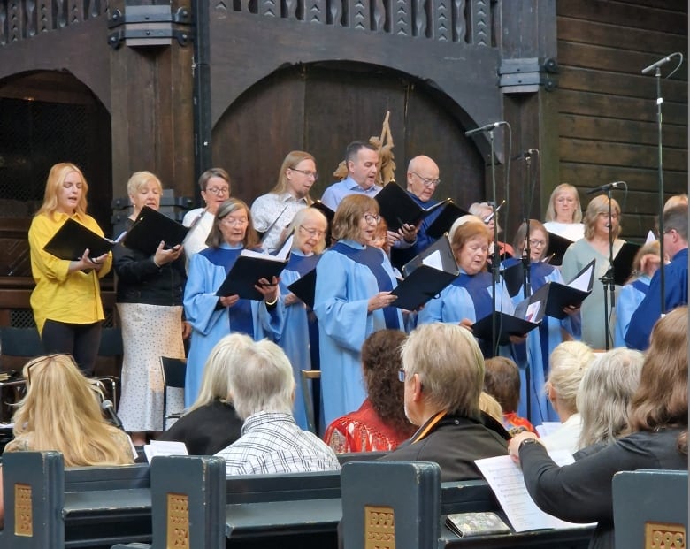 A choir performs at a church altar