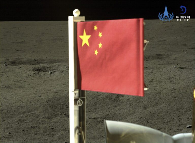 Craft unfurls China’s flag on the far side of the moon and lifts off with lunar rocks to bring home