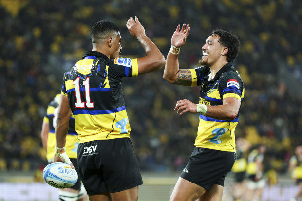 Salesi Rayasi of the Hurricanes celebrates with Billy Proctor after scoring a try.