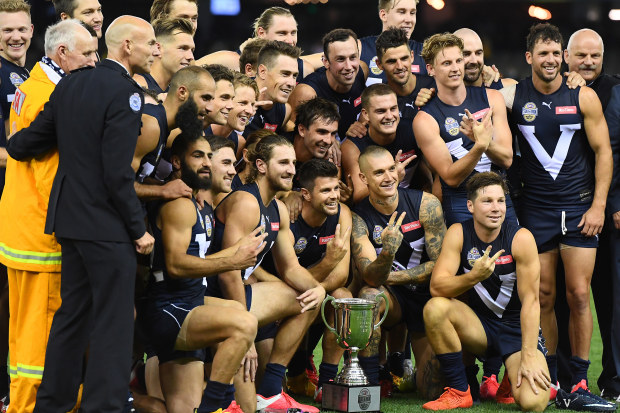 The Victorian players pose with the trophy after winning the AFL Bushfire Relief State of Origin match in 2020.