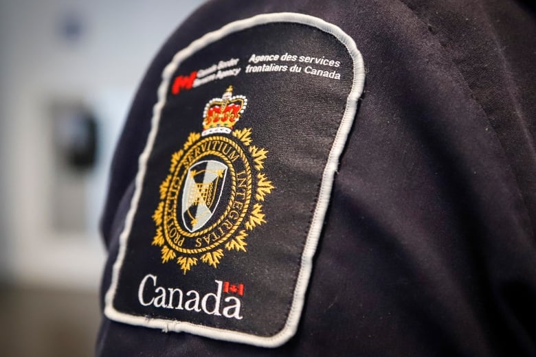 A close up picture of a Canada Border Services Agency badge.