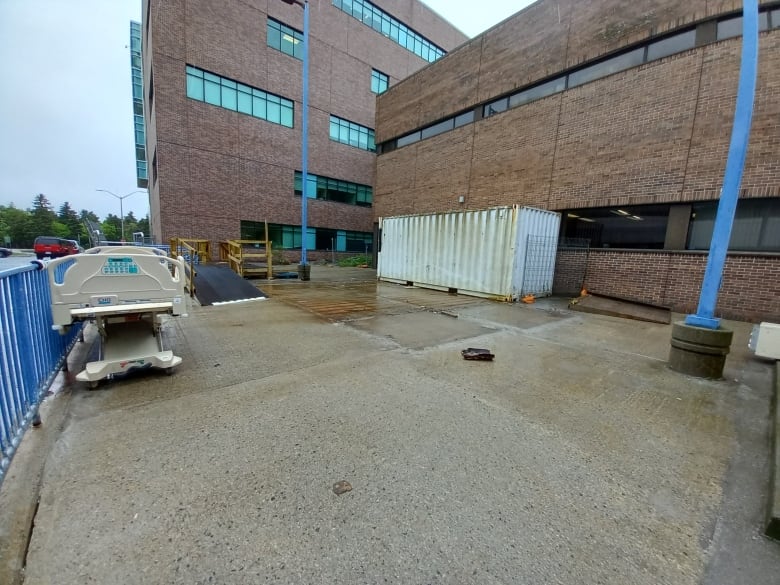 Photo of loading bay area in back of brick building