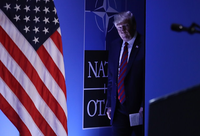 President Donald Trump arrives to speak to the media at a press conference on the second day of the 2018 NATO Summit 