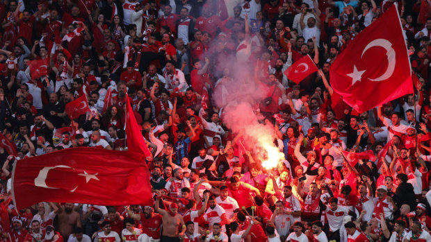 LEIPZIG, GERMANY - JULY 02: Fans of Turkey with red flares and flags during the UEFA EURO 2024 round of 16 match between Austria and Turkiye at Football Stadium Leipzig on July 02, 2024 in Leipzig, Germany. (Photo by James Baylis - AMA/Getty Images)