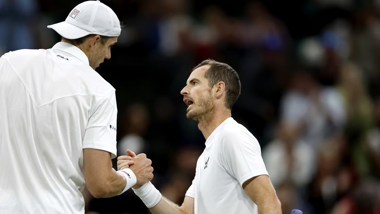 Great Britain's Andy Murray (right) shake hands with USA's John Isner after defeat in the second round match on centre court during day three of the 2022 Wimbledon Championships at the All England Lawn Tennis and Croquet Club, Wimbledon. Picture date: Wednesday June 29, 2022.