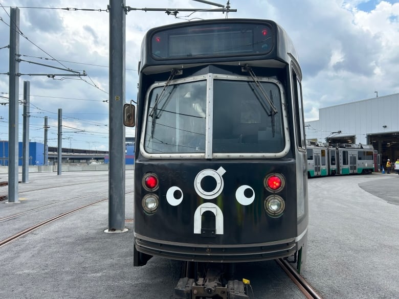 A black train with a pair of googly eyes on the front.