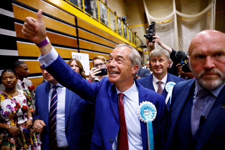 Britain's Reform UK Party Leader Nigel Farage gestures as he walks after winning his first seat in parliament during the UK election in Clacton-on-Sea, Britain, July 5, 2024. 