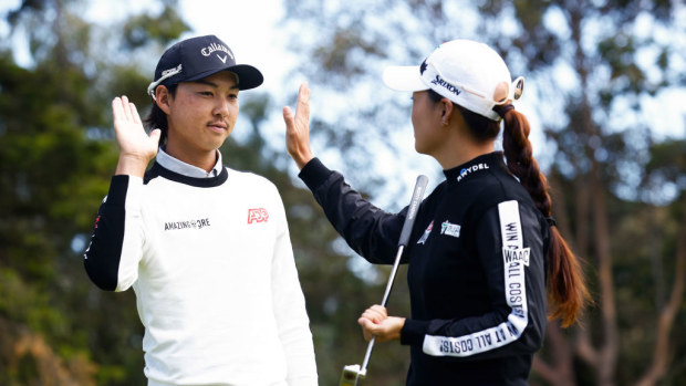 Minjee Lee and Min Woo Lee high five.