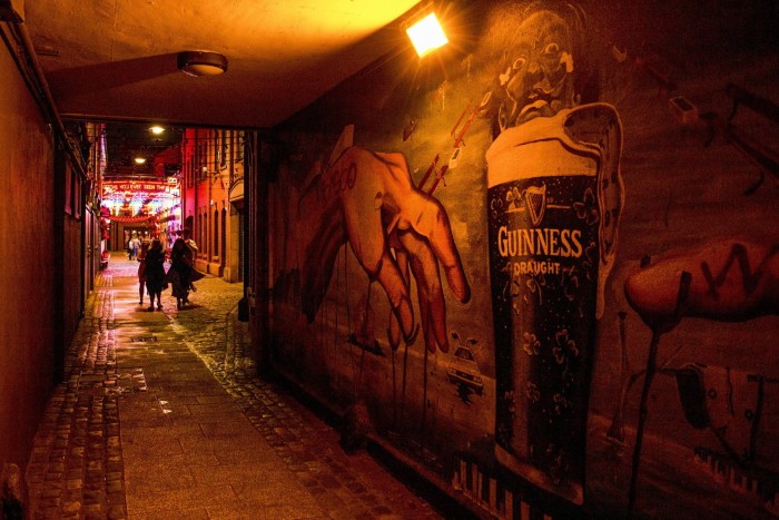 A mural in Belfast, Northern Ireland, featuring an image of a pint of Guinness