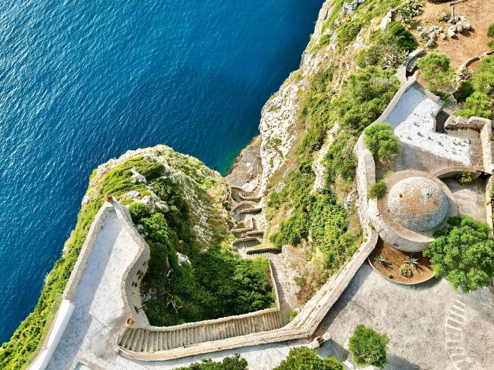 A view of the stone stairs on the cliffside that lead down to a private bathing cove