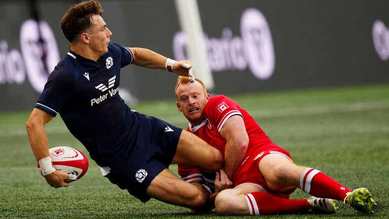 Jamie Dobie looks to offload out of a tackle