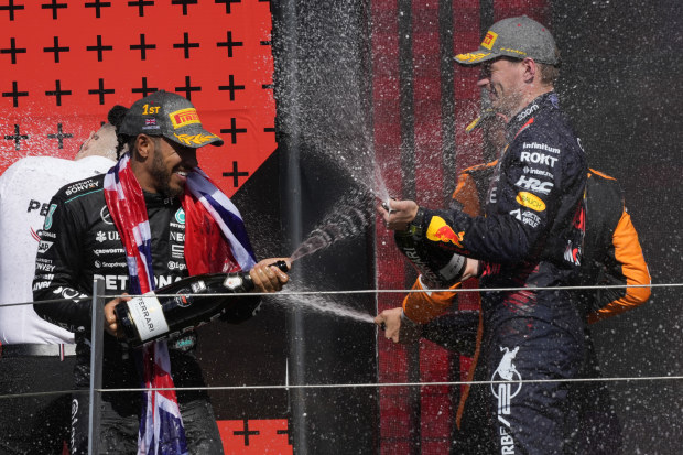 Mercedes driver Lewis Hamilton of Britain, left, celebrates on the podium with second placed Red Bull driver Max Verstappen of the Netherlands.