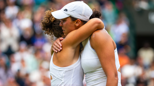 Jasmine Paolini and Madison Keys embrace at the net as Keys is forced to retire with injury from their fourth-round meeting.