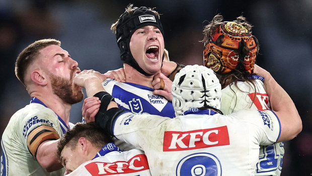 Bulldogs teammates swamp Matt Burton after a match-winning field-goal against the Sharks in round 17.