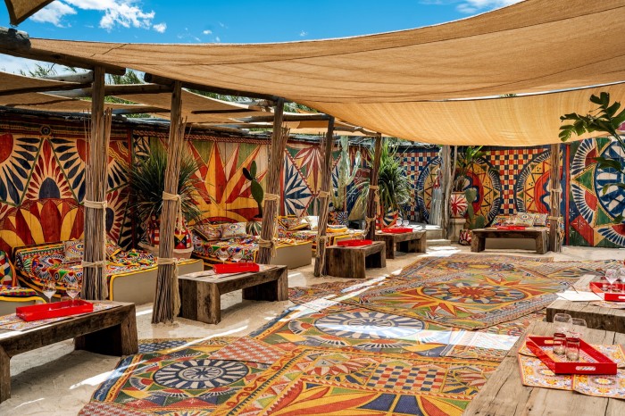 A colorful outdoor seating area with a bohemian, ethnic-inspired design