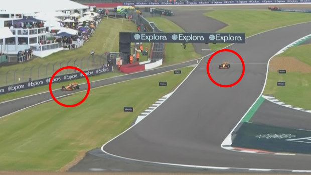 Oscar Piastri (left) pits from the lead with teammate Lando Norris (right) close behind as rain soaks the Silverstone circuit during the British Grand Prix.