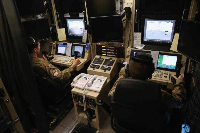 A US Air Force pilot and an operator prepare to launch an unmanned aerial vehicle from a base in the Gulf region