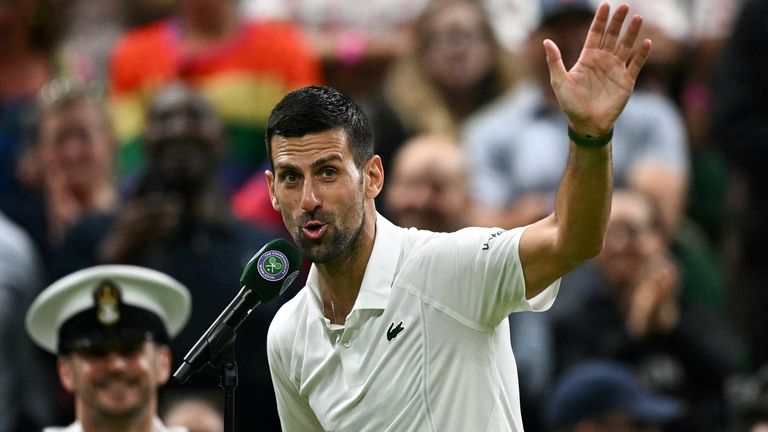 Winner Serbia's Novak Djokovic speaks during an interview and reacts to the cheering of the crowd at the end of his men's singles tennis match against Denmark's Holger Rune on the eighth day of the 2024 Wimbledon Championships at The All England Lawn Tennis and Croquet Club in Wimbledon, southwest London, on July 8, 2024. (Photo by Ben Stansall / AFP) / RESTRICTED TO EDITORIAL USE