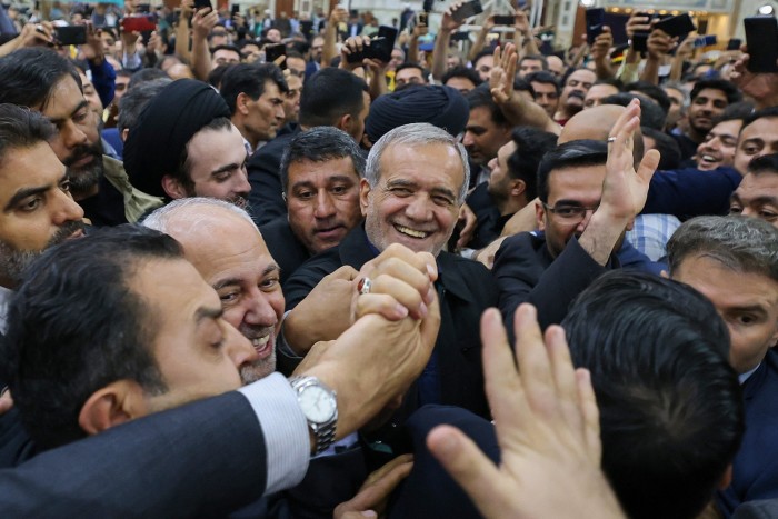 Newly elected Iranian President Masoud Pezeshkian arrives at the shrine of the Islamic Republic’s founder, Ayatollah Ruhollah Khomeini, in Tehran on July 6 as supporters cheer