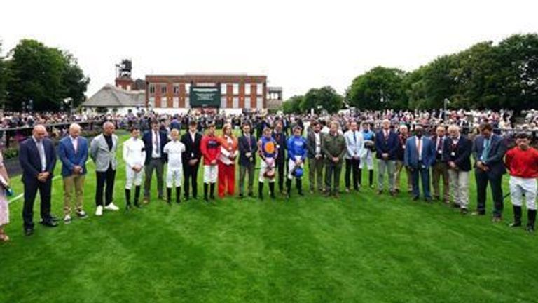 A minute silence is observed for Carol, Louise and Hannah Hunt ahead of Ladies Day during The July Festival 2024 at Newmarket Racecourse.