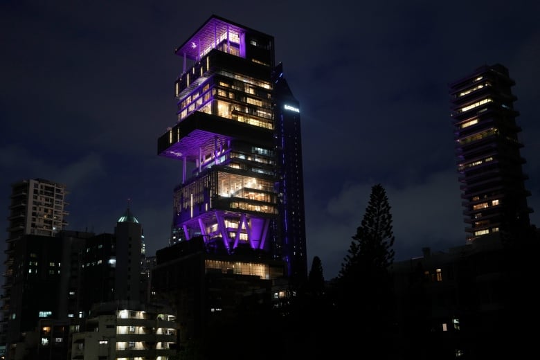 An apartment is lit up at night. 