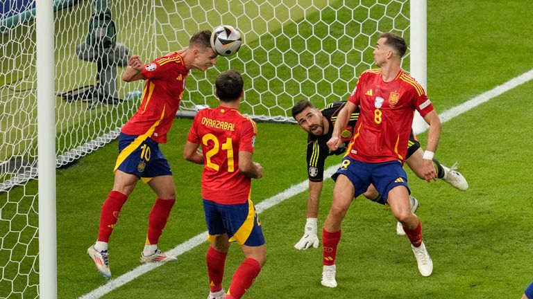 Spain's Dani Olmo clears the ball from the goal line during the final match between Spain and England at the Euro 2024 soccer tournament in Berlin, Germany, Sunday, July 14, 2024. (AP Photo/Andreea Alexandru)