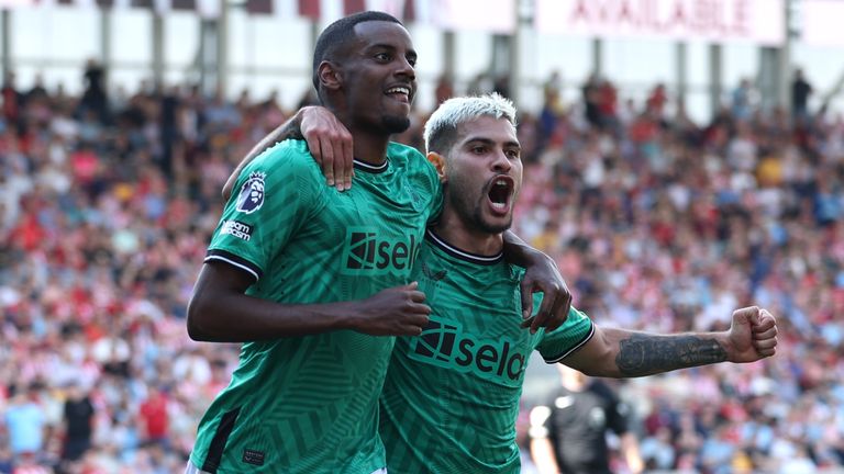 Alexander Isak celebrates with Bruno Guimaraes after scoring Newcastle's third goal at Brentford