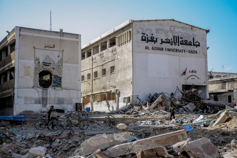 Rubble surrounds two buildings.