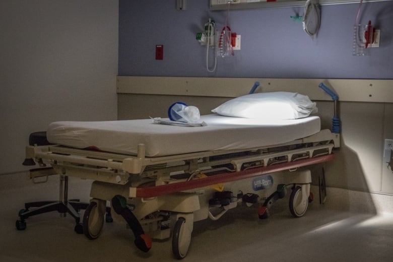 A hospital bed on wheels is shown.