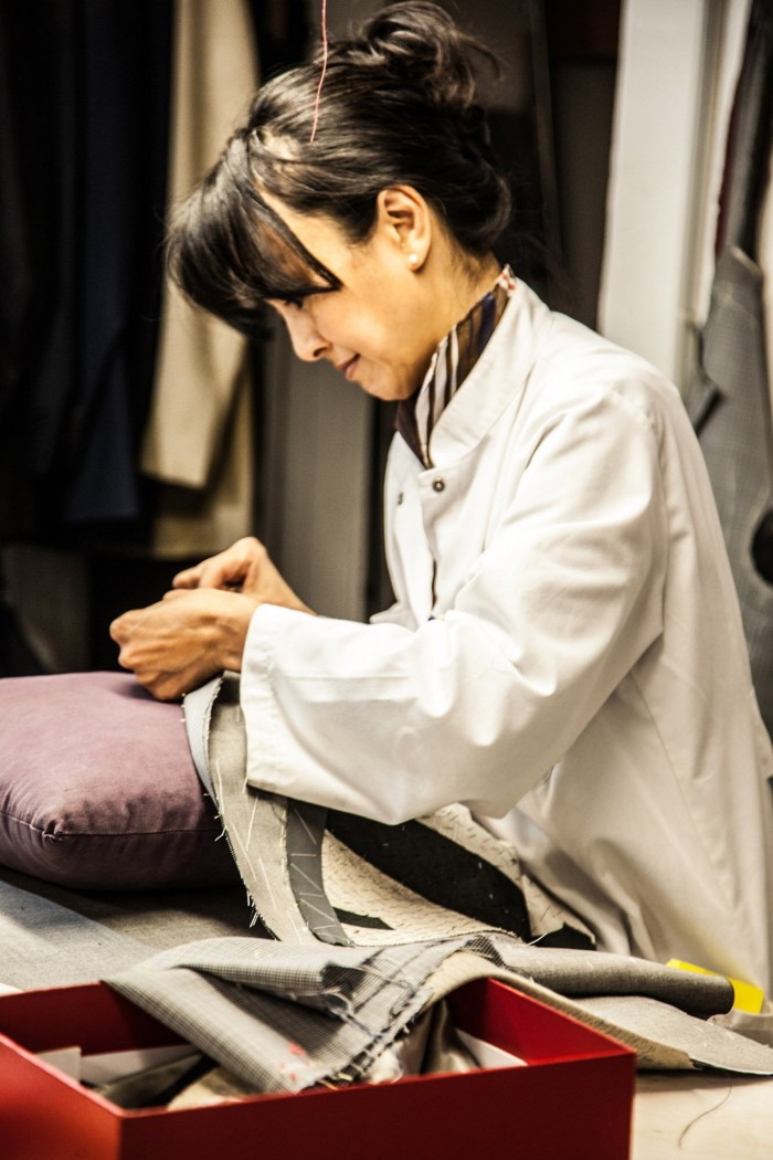 A woman pins fabric together