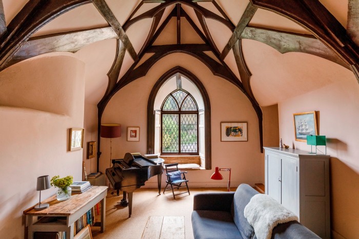 the interior of a medieval manor house with beamed pointed ceilings 