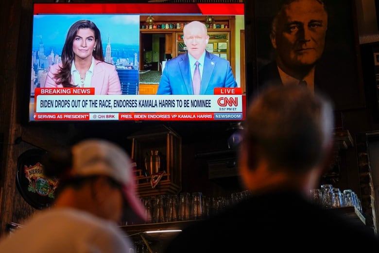 News coverage of U.S. President Joe Biden's decision to exit his re-election bid is seen playing on a television at an Atlanta tavern on Sunday.