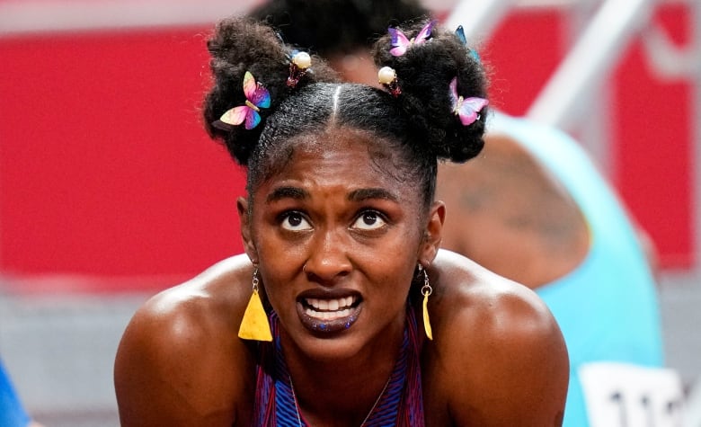 A woman with dangly earrings and hair clips