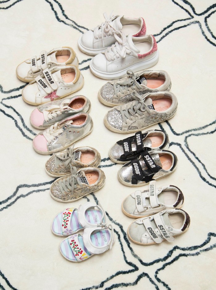 a lineup of luxury shoes worn by Irene Kim’s children 