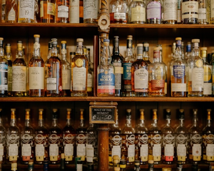 Shelves of different bottles of whisky at The Bow Bar