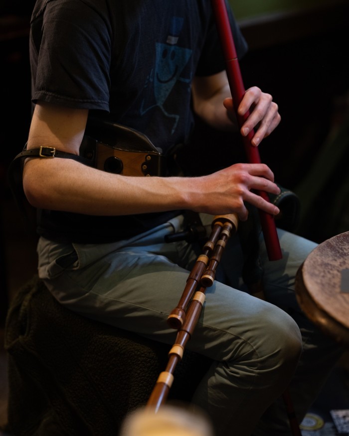 A man playing a set of traditional pipes at Sandy Bell’s