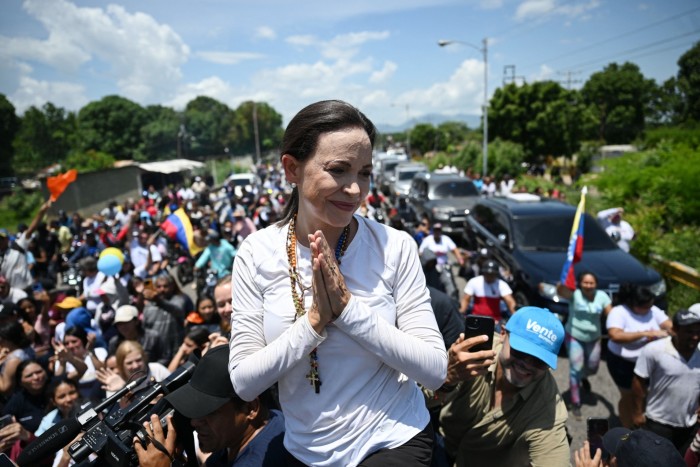 Machado gestures to supporters during the drive between Lara and Zulia states