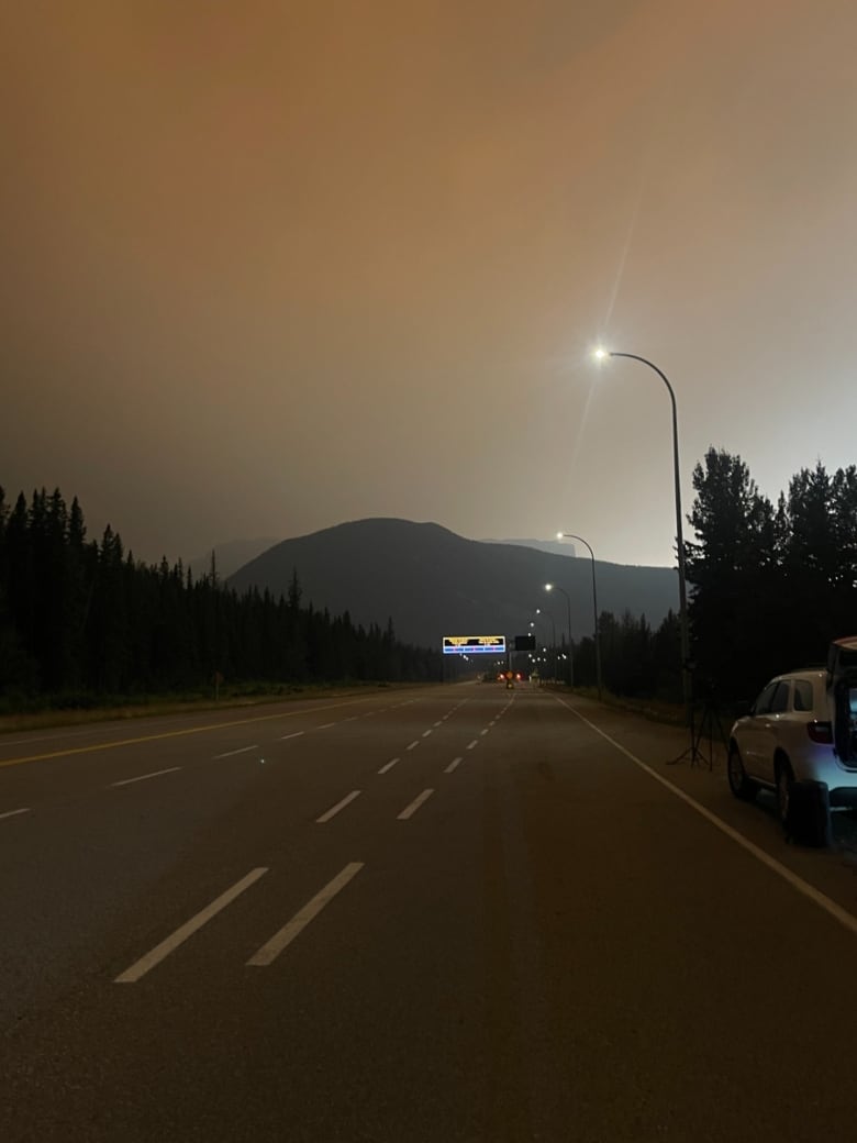 An empty highway with smoke in the air. 