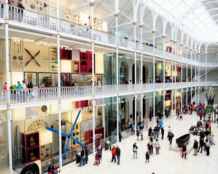 A large three-storey gallery featuring various exhibits at the National Museum of Scotland