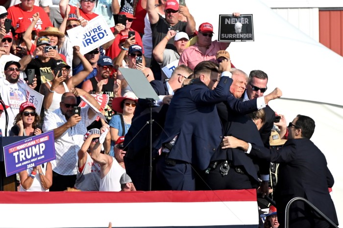 Secret service agents lead Trump off stage after an assassination attempt on the former president at a Pennsylvania rally