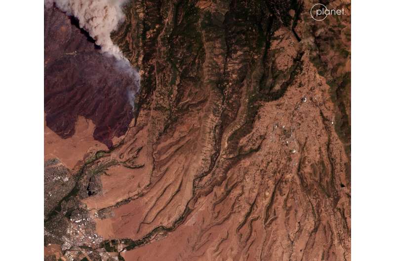 This aerial photo, taken above the town of Chico, California on July 25, 2024, shows smoke rising from the huge Park Fire