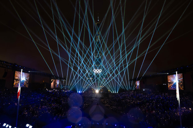 The Eiffel Tower is lit up with the Olympic Rings to close the opening ceremony.