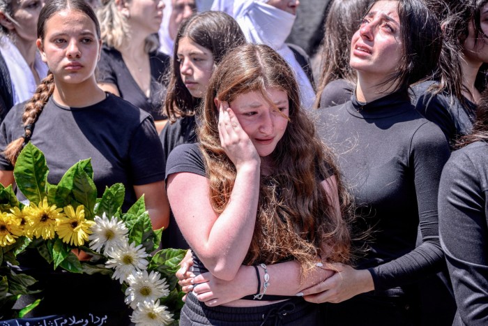 Mourners burst into tears during the funeral. Hizbollah has now denied responsibility for the strike 