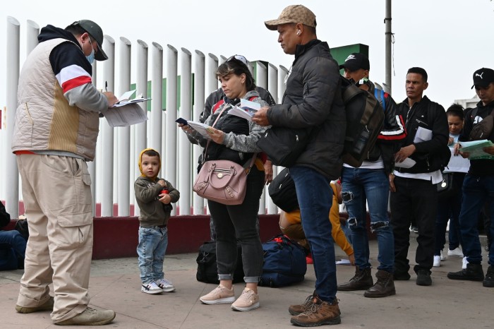 Asylum seekers arrive at the El Chaparral border crossing point