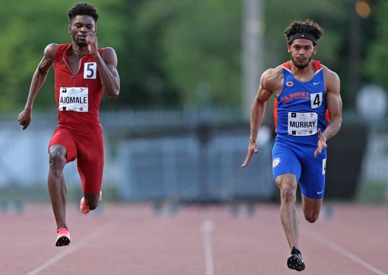 Two men run on a track.