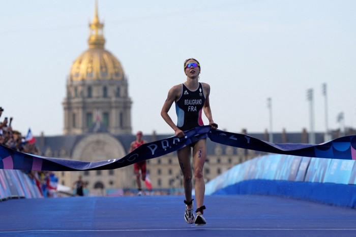 Cassandre Beaugrand of France crosses the finish line to win the gold medal in the women’s individual triathlon in the Paris Olympics on July 31 2024