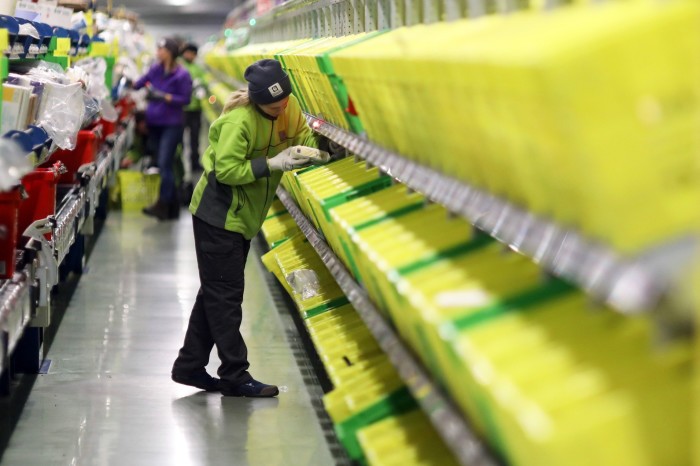 A worker picks out an order at an Ocado distribution 