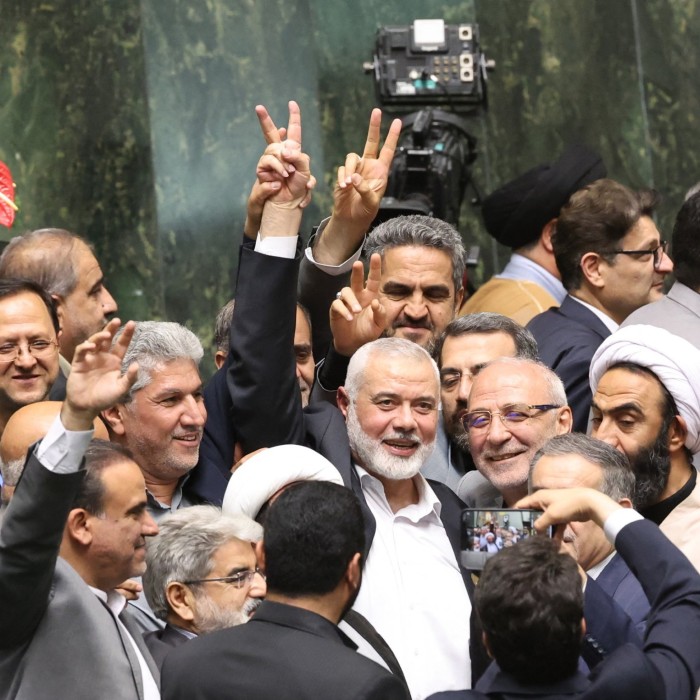 Ismail Haniyeh flashes a victory sign in Tehran