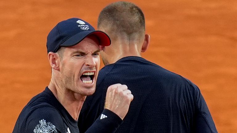 Andy Murray, left, and Daniel Evans of Britain celebrate a point during their match against Joran Vliegen and Sander Gille of Belgium during the men's doubles tennis competition at the Roland Garros stadium, at the 2024 Summer Olympics, Tuesday, July 30, 2024, in Paris, France. (AP Photo/Manu Fernandez)